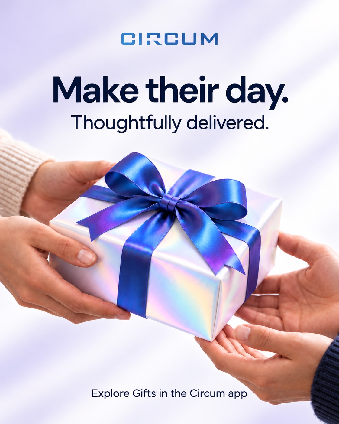 An iridescent gift with a blue ribbon being passed between two people